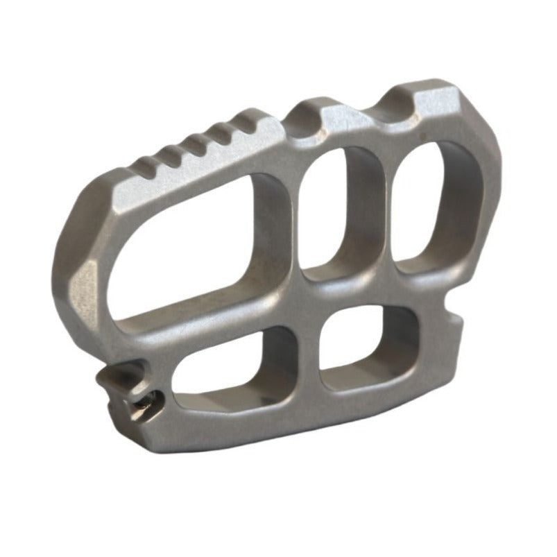 Stainless steel knuckle duster lifestyle shot on dark surface
