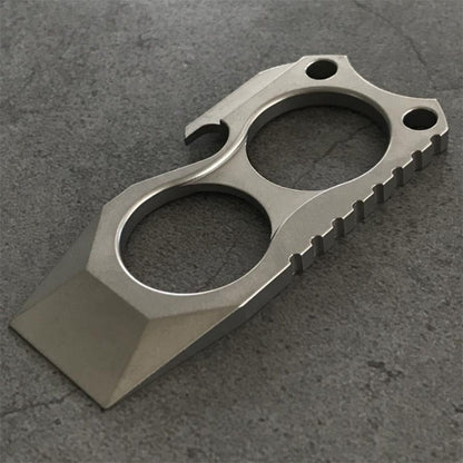 Titanium 2-finger crowbar knuckle duster front view on stone surface