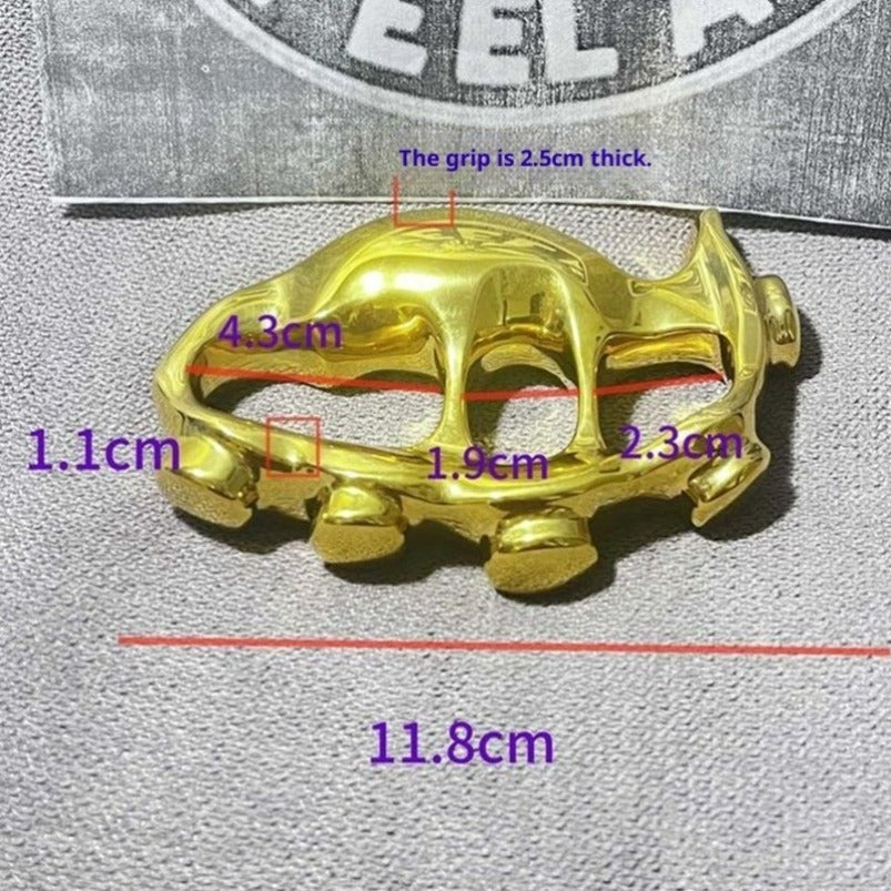 Polished golden brass knuckle duster front view showing sculpted design