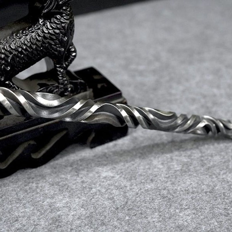 Twisted carved pattern detail on forged metal hand stick