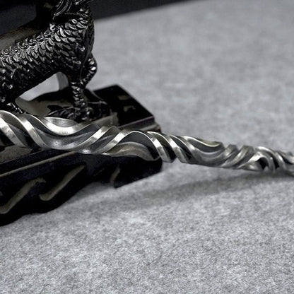Twisted carved pattern detail on forged metal hand stick