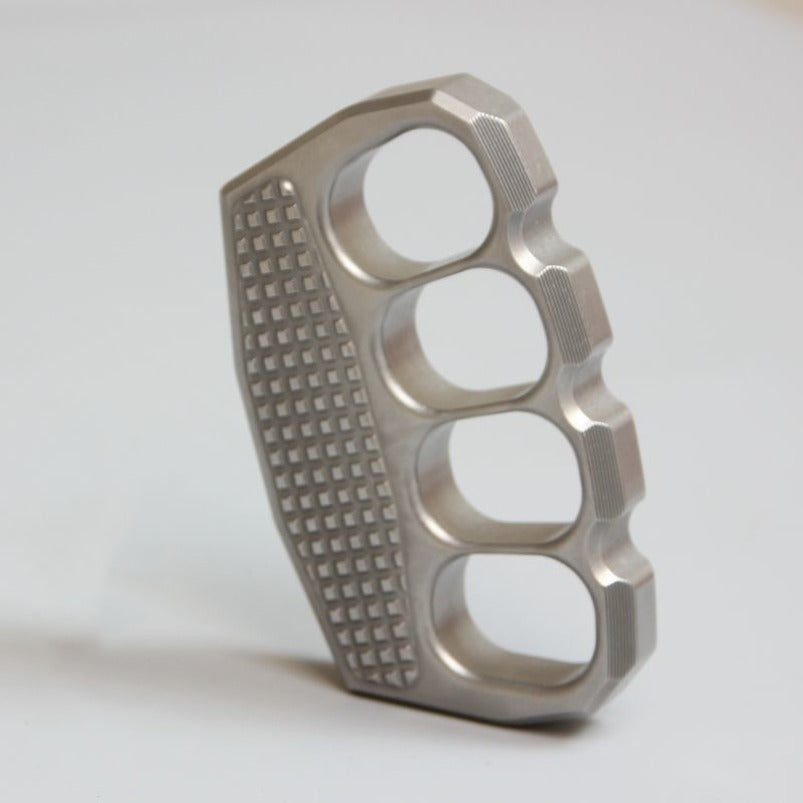 Angled view of non-slip stainless steel knuckle duster on white background