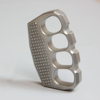 Angled view of non-slip stainless steel knuckle duster on white background