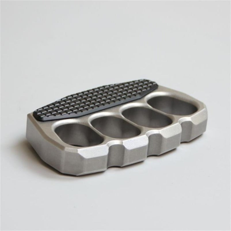 Angled view of magnetic steel knuckle duster on white background