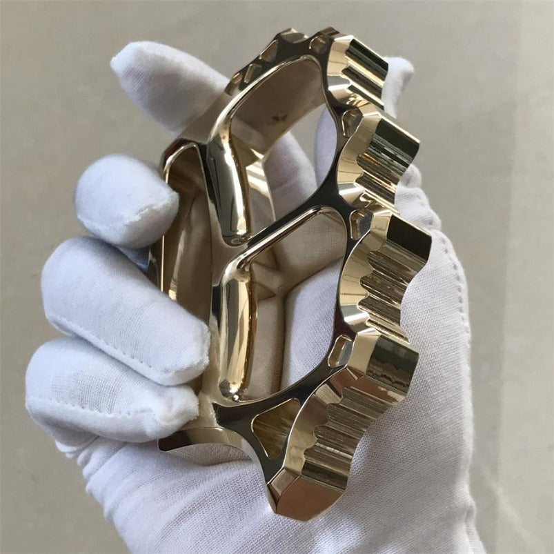Detail shot of mirror polished brass knuckle duster surface