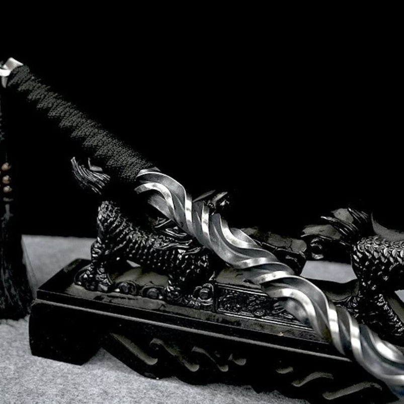 Martial arts hand stick displayed with tassel draped over stand