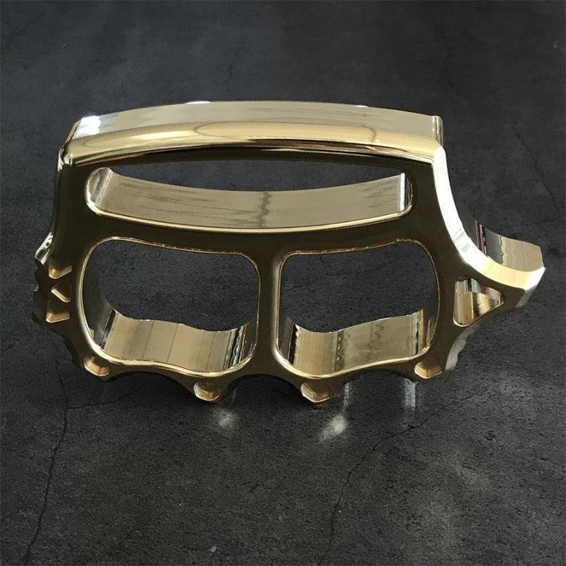 Top angle of brass knuckle duster showing window breaker profile